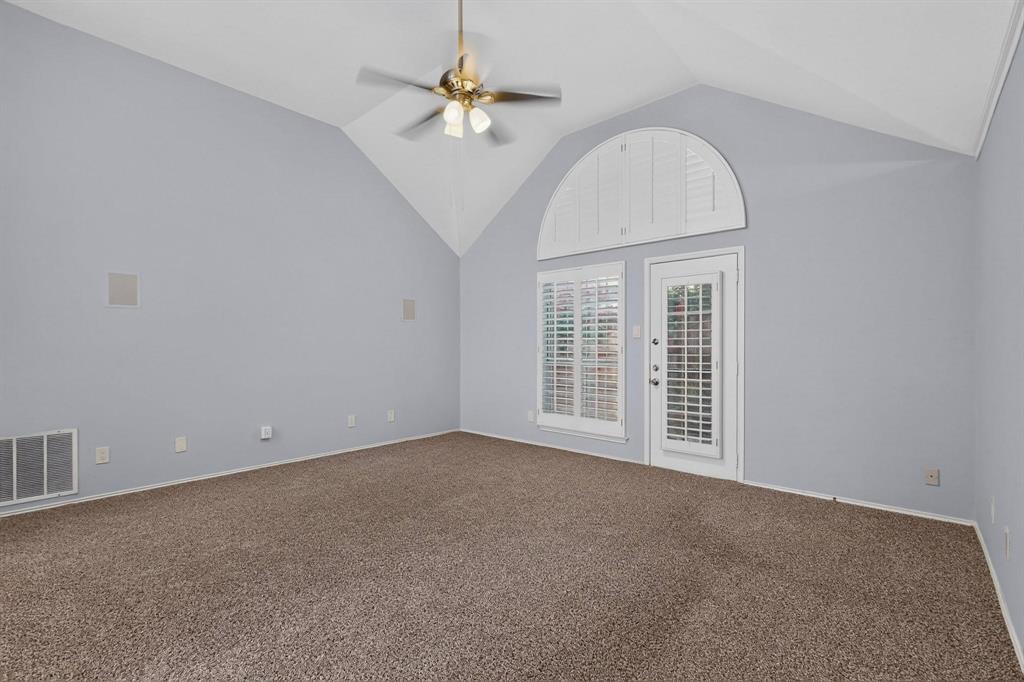 Vaulted ceiling with a brass-finish ceiling fan and light fixture