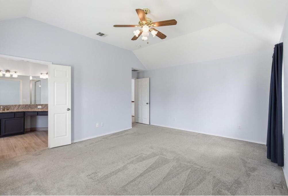 Vaulted ceiling with a ceiling fan