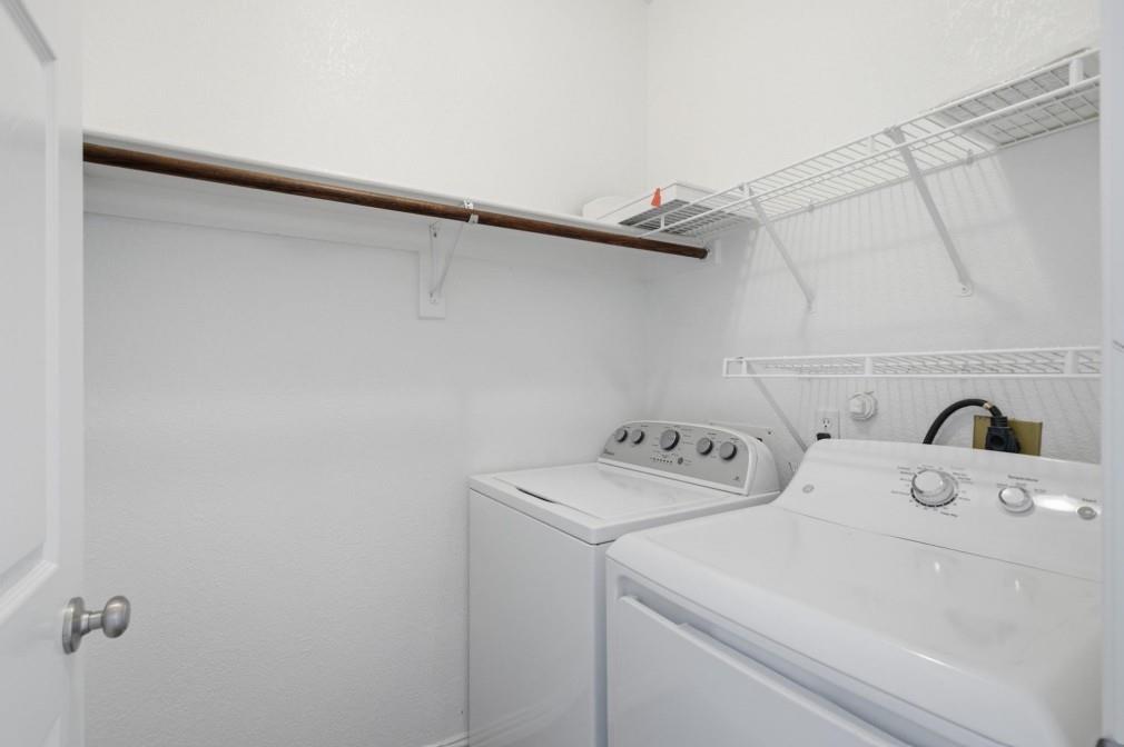 Laundry area with overhead hanging rod and wire shelving