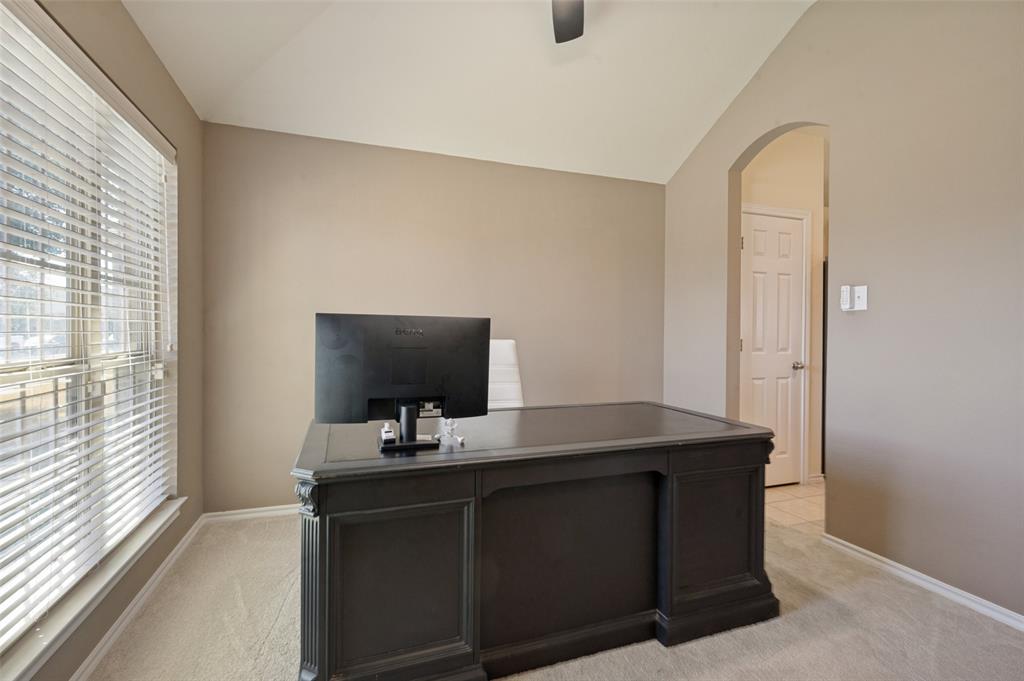 Window with horizontal blinds, neutral wall paint, vaulted ceiling, and an arched doorway Window with horizontal blinds, neutral wall paint, vaulted ceiling, and an arched doorway