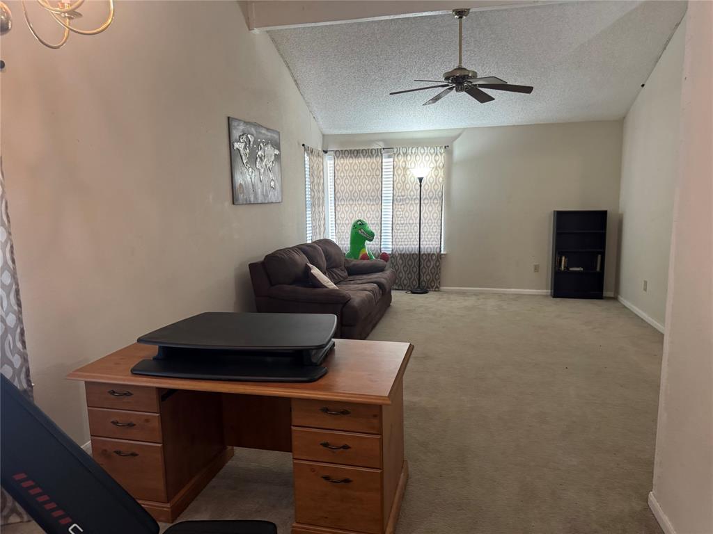 Vaulted ceiling, ceiling fan, chandelier, carpeted flooring, tiled flooring in entryway