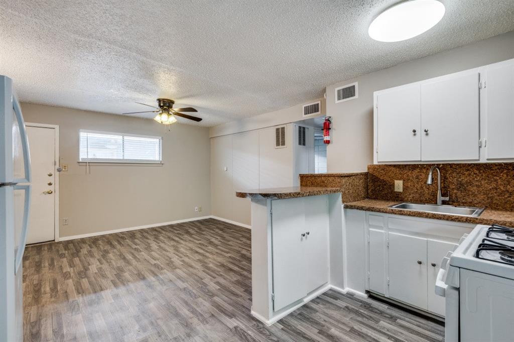 Kitchen featuring white cabinetry and a breakfast bar