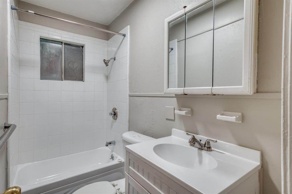 White subway tile shower surround with a built-in window