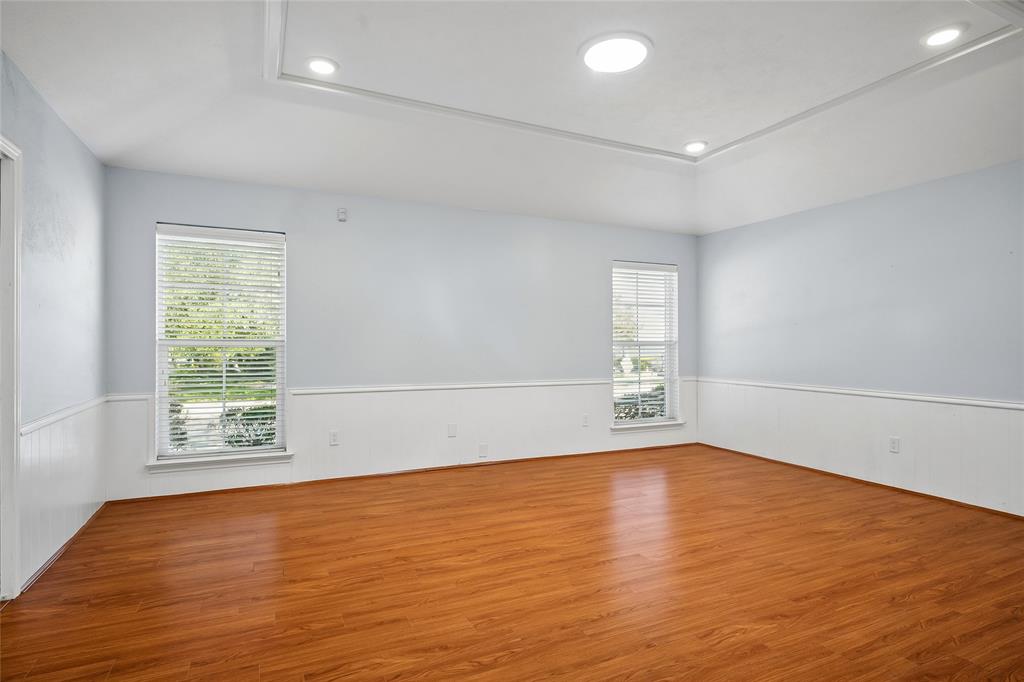 Spacious family room has a pocket door opening  to the kitchen.  Solar tubes are in both living areas, the hall, and bathrooms.