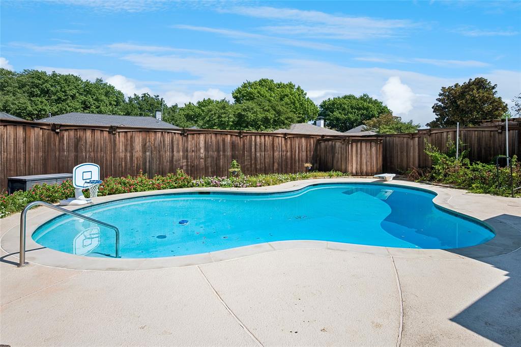Sparkling pool is accented by the flowering landscape.
