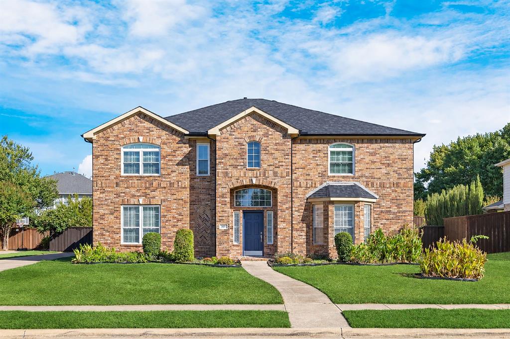 Brick exterior with a dark shingle roof and a two-story bay window Brick exterior with a dark shingle roof and a two-story bay window
