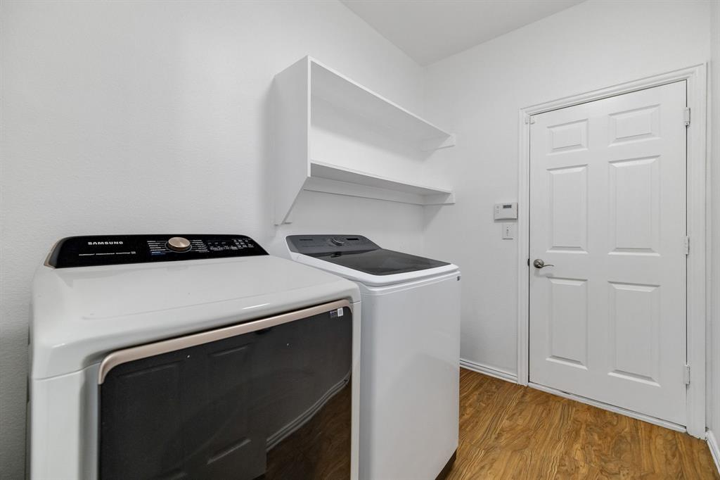 Wall-mounted shelving, wood-finish flooring, and a paneled door