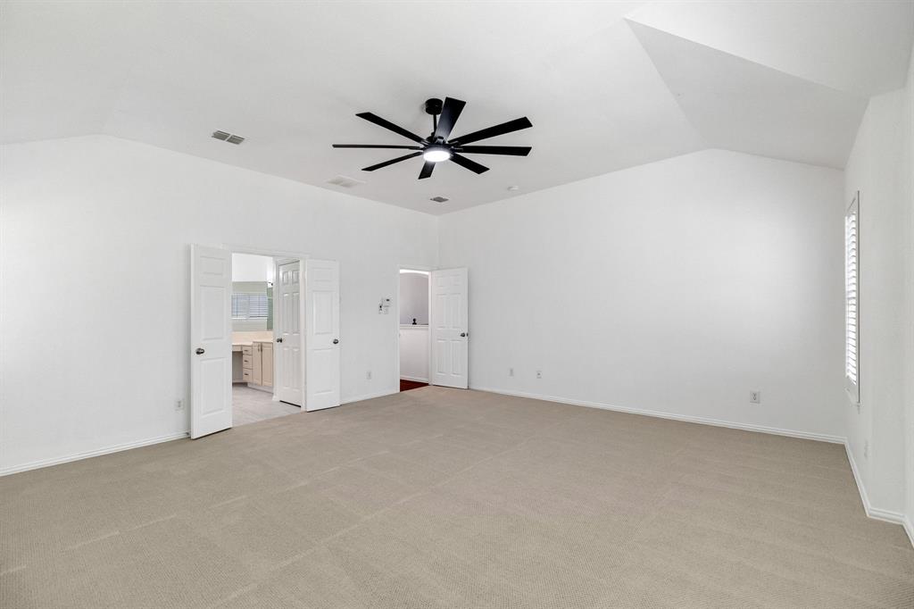Spacious room with vaulted ceilings and recessed lighting