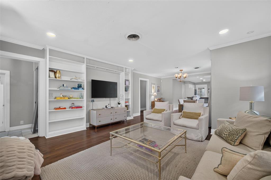 Hardwood flooring, recessed lighting, crown molding, built-in shelving, and an open-concept layout