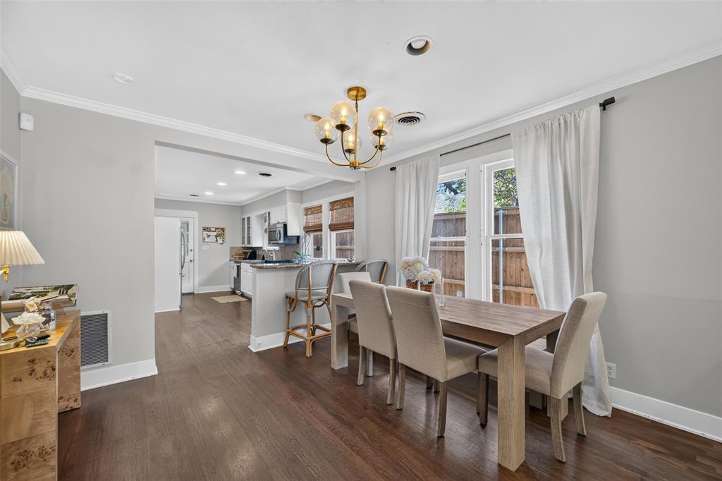 Wood-finish flooring throughout, recessed lighting, and a multi-light chandelier