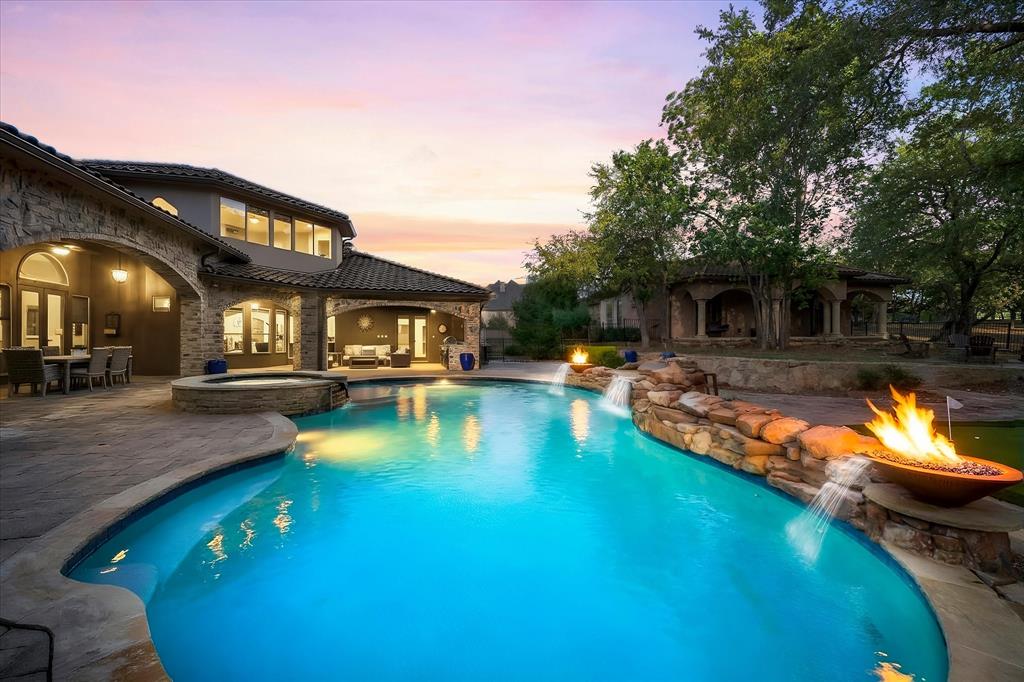 Oversized Pool, Raised Spa, Waterfall with two fire bowls & water features as well. Guest Residence in back ground.