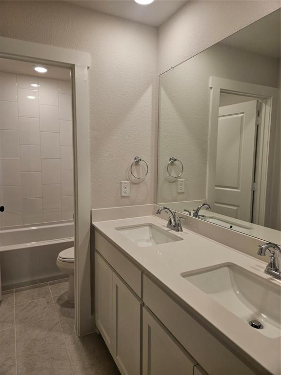 Dual vanity with integral sinks, light-toned countertops, and chrome fixtures