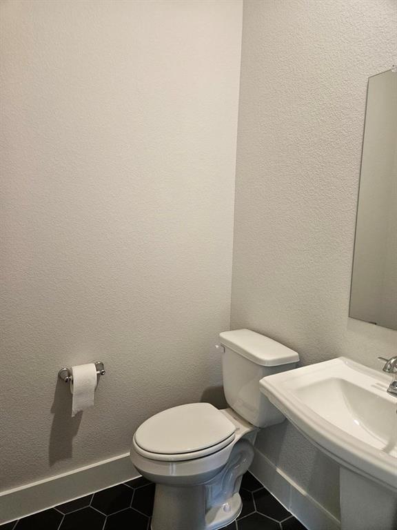 White pedestal sink with chrome faucet