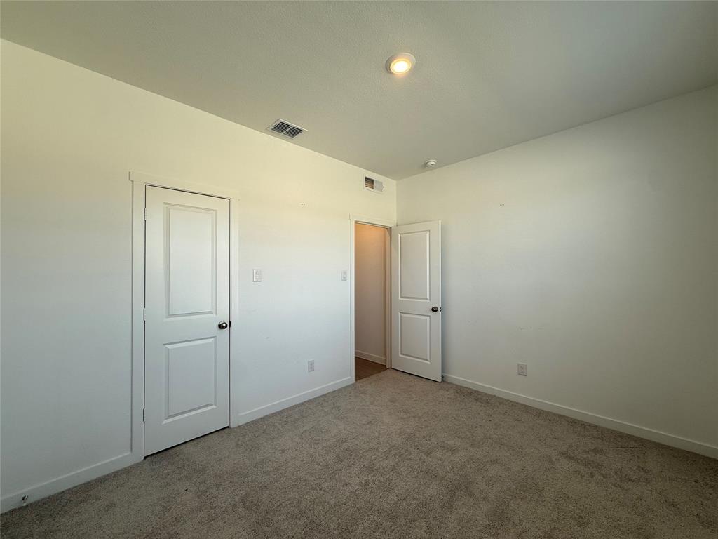 Neutral wall finishes, recessed lighting, and carpeted flooring