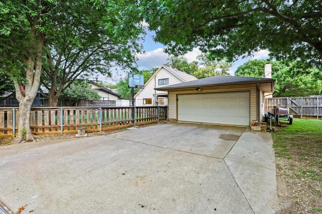 The rear facing garage has a large driveway and alley access with an electric privacy gate for added security