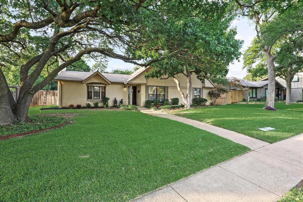 Welcome home to a peaceful setting with lush green lawn and beautiful mature trees