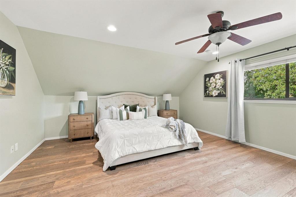 Large primary bedroom with wood floors