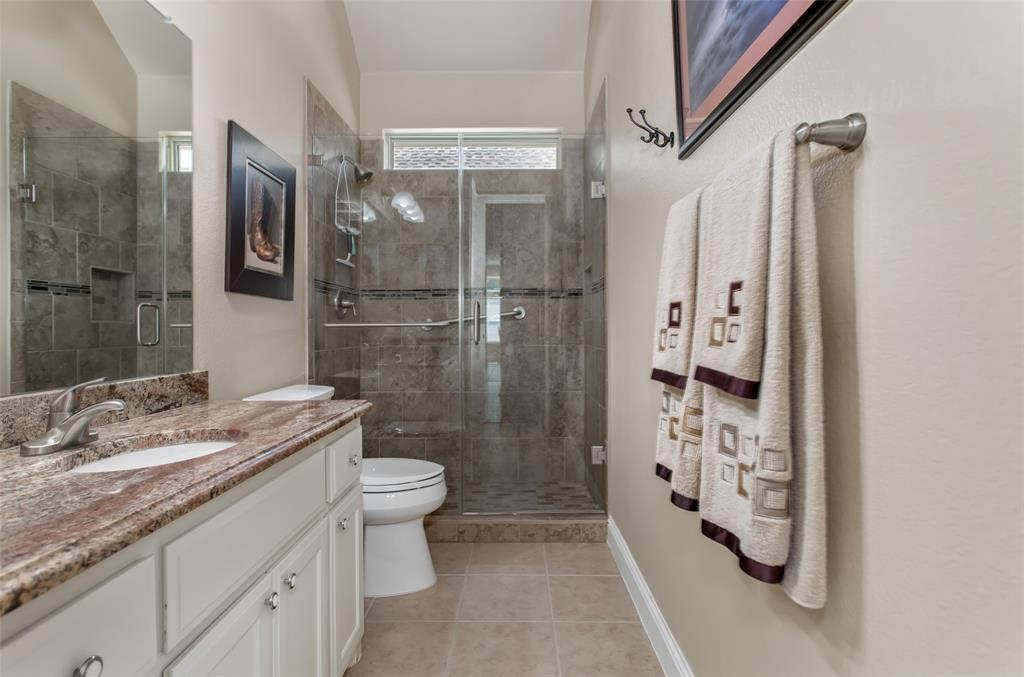 White vanity with a stone countertop and integrated sink