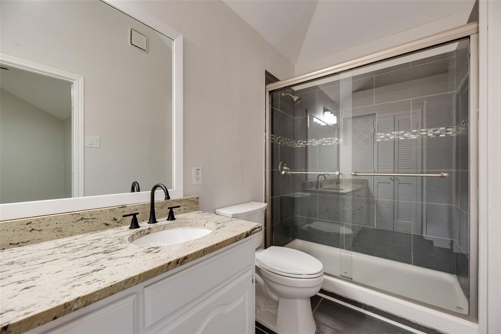 Vanity with a granite countertop, undermount sink, and matte black faucet Vanity with a granite countertop, undermount sink, and matte black faucet
