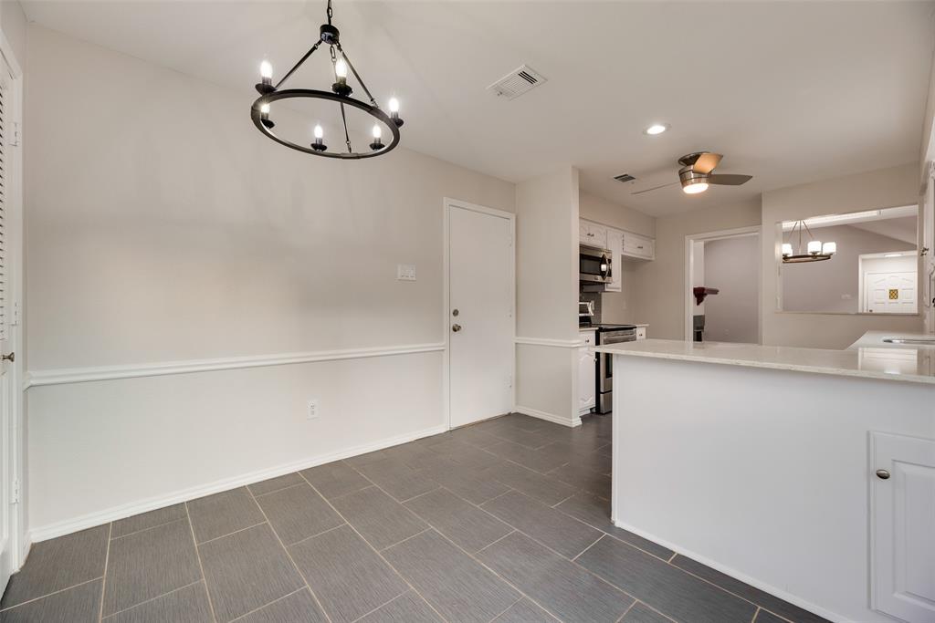 Porcelain tile flooring, crown molding, modern chandelier, breakfast bar with stone countertop, stainless steel appliances Porcelain tile flooring, crown molding, modern chandelier, breakfast bar with stone countertop, stainless steel appliances