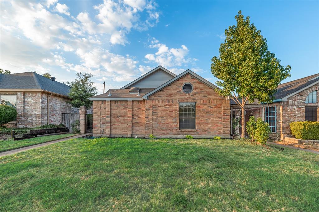 Brick exterior with a gabled roofline and round accent window Brick exterior with a gabled roofline and round accent window