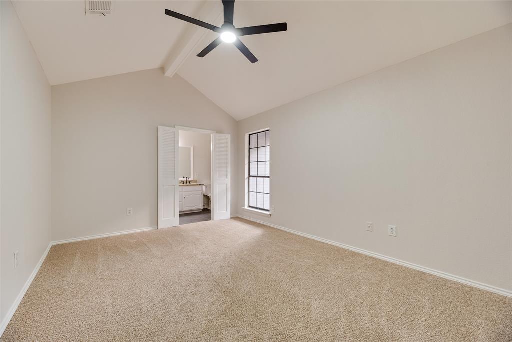 Vaulted ceiling, carpet flooring, ceiling fan, and double-pane window