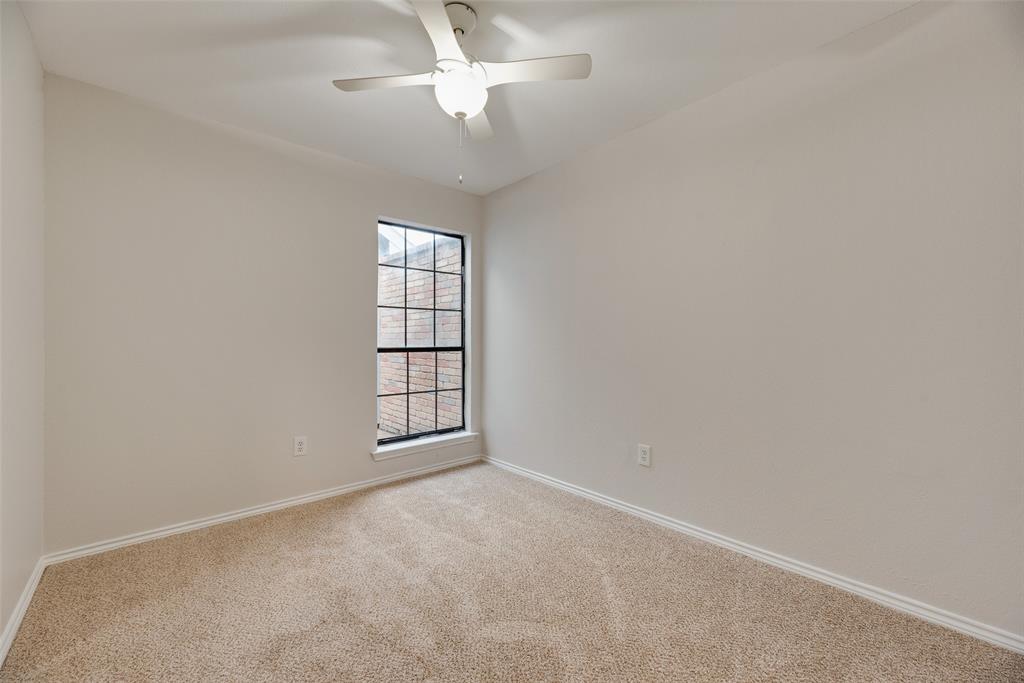 Carpeted flooring, neutral wall tones, and a ceiling fan with integrated lighting Carpeted flooring, neutral wall tones, and a ceiling fan with integrated lighting