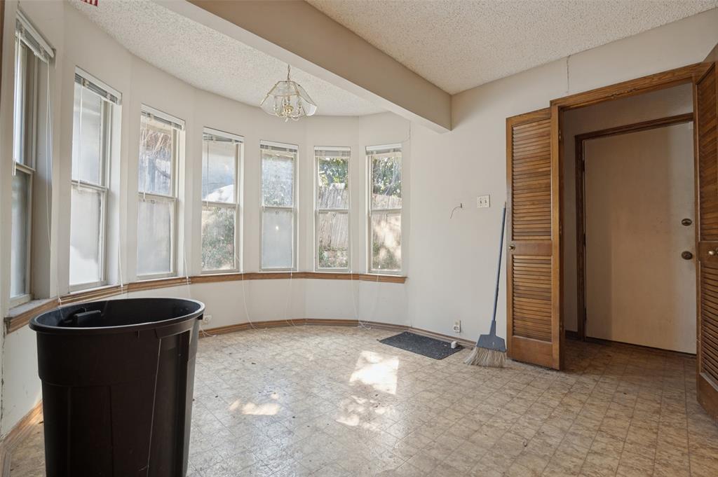 Bay window feature with multiple vertical windows, louvered bi-fold doors, and a ceiling-mounted light fixture