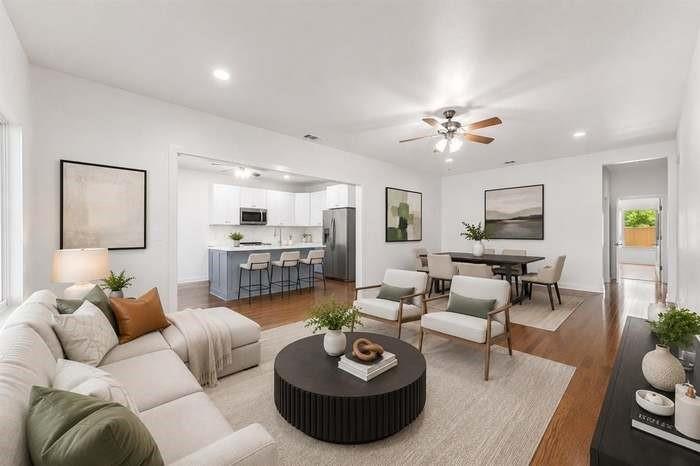 Hardwood-finish flooring, recessed lighting, and a ceiling fan in the main living space
