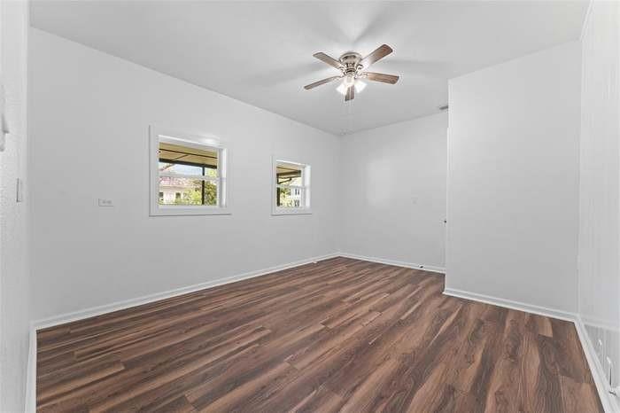 Wood-finish flooring with white baseboards