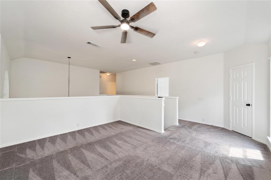 Open landing area featuring patterned carpet flooring, a ceiling fan, and recessed lighting