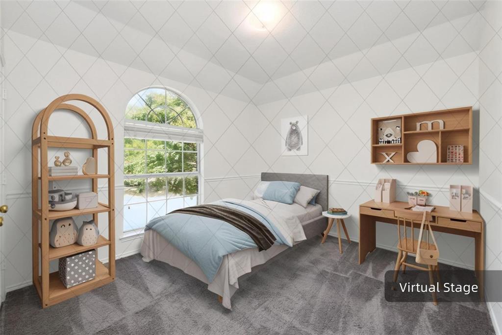 Arched window with exterior views, patterned wall treatment, wall-mounted shelving, built-in desk, and gray carpeting