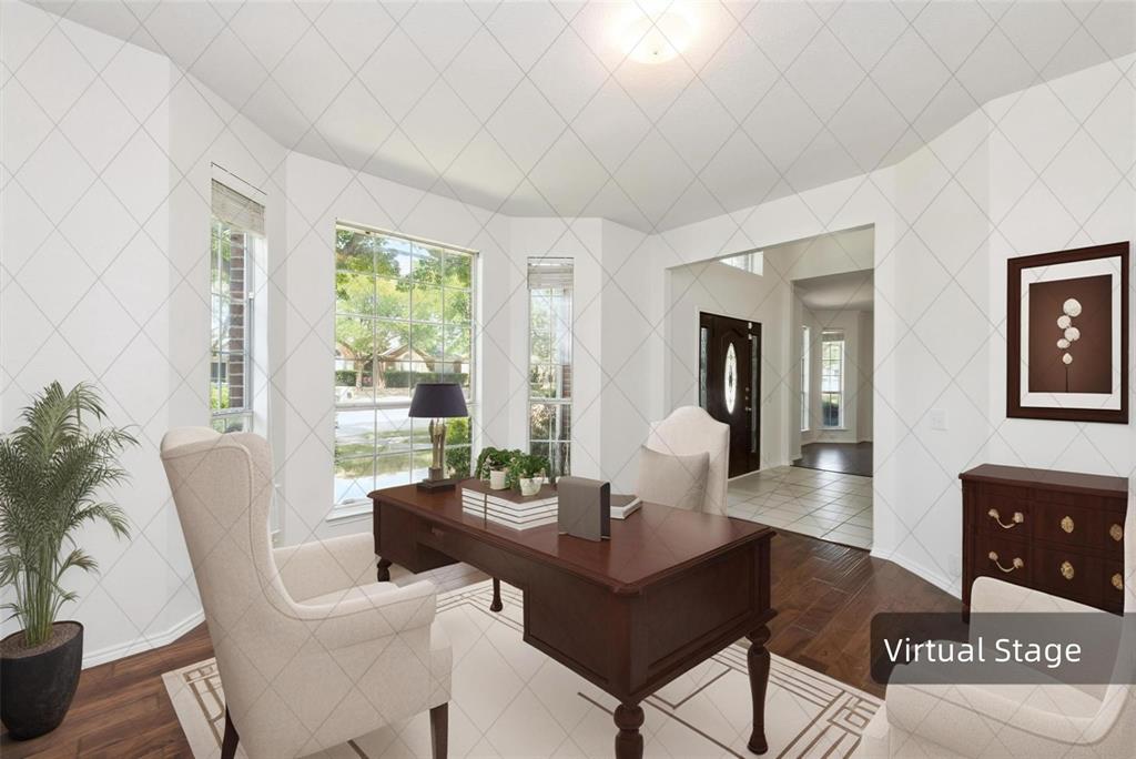 Hardwood flooring, bay windows, recessed ceiling light, arched doorway, and white wall finishes