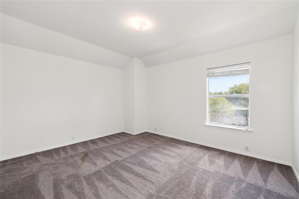 Recessed ceiling light fixture, framed window, and patterned carpet