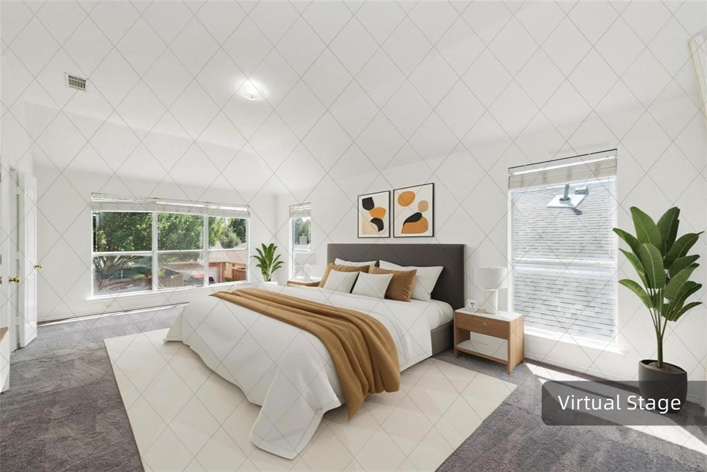 Vaulted ceiling with an integrated light fixture, multiple windows with blinds, gray carpet flooring, and white walls