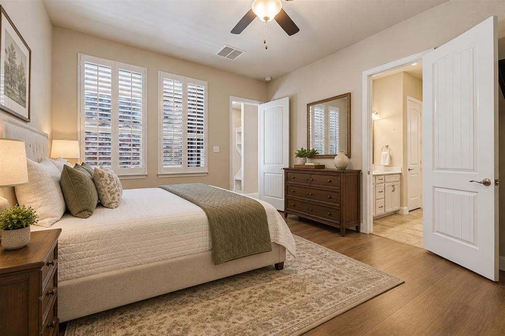 Spacious downstairs primary bedroom with plantation shutters - virtually staged