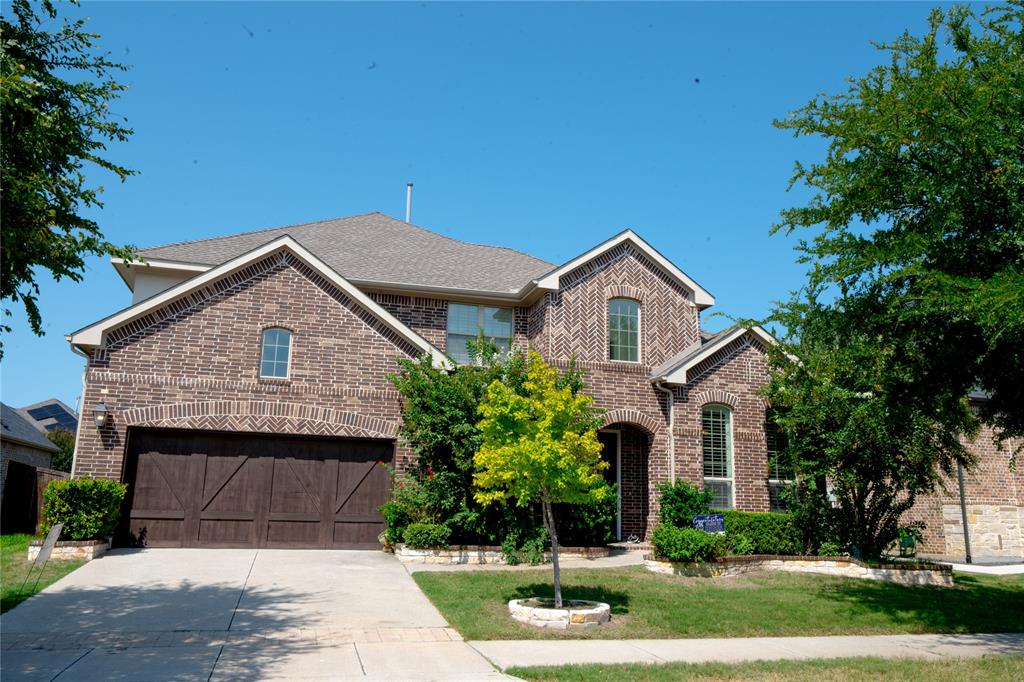 Brick exterior with stone accents, arched windows, and a multi-gabled roofline