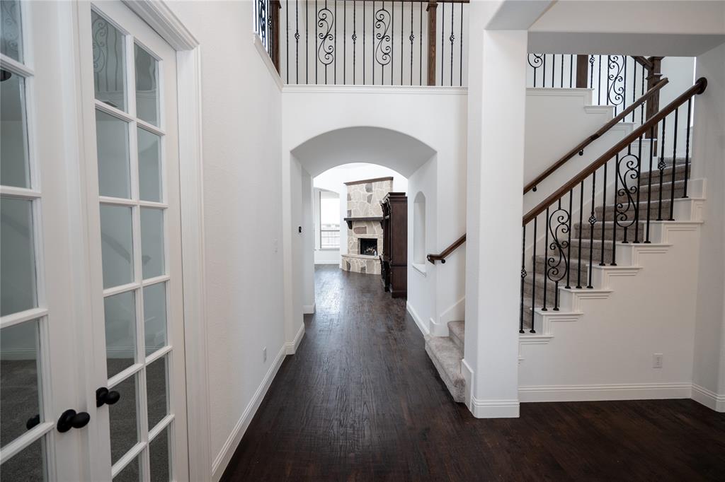 Dark wood-finish flooring throughout the main corridor