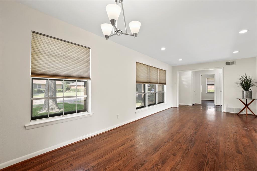 Wood-finish flooring, recessed lighting, and a contemporary chandelier