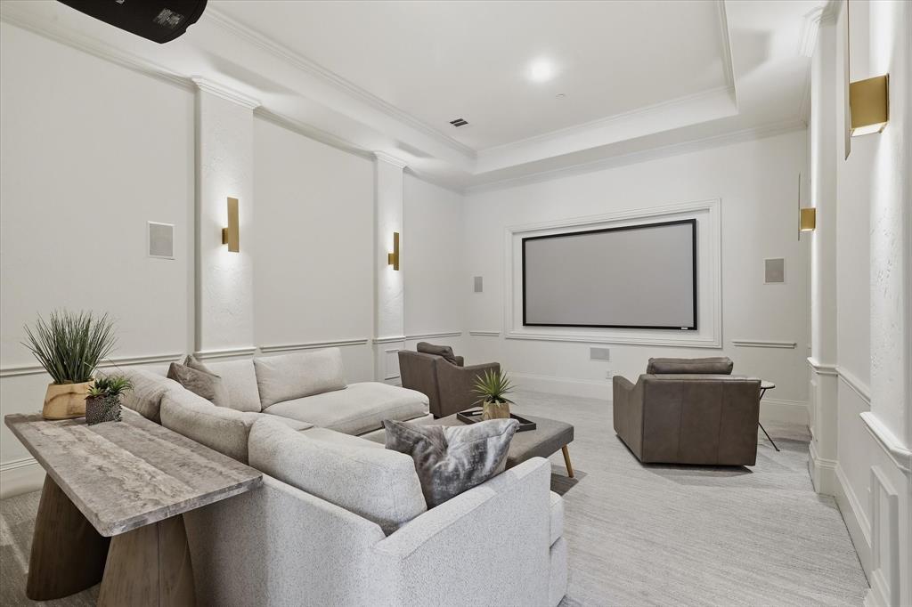 The main-level media room offers a comfortable, dedicated setting for movie nights and game days.