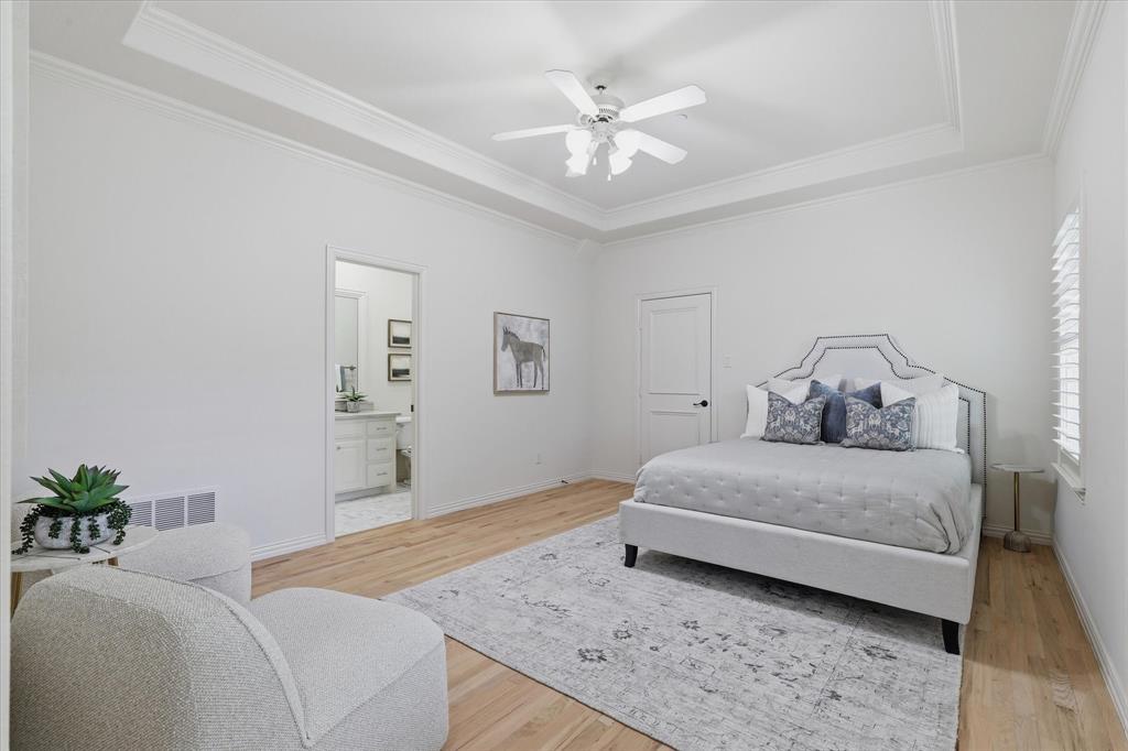 The third upstairs bedroom is generously sized and includes its own private bath and walk-in closet.