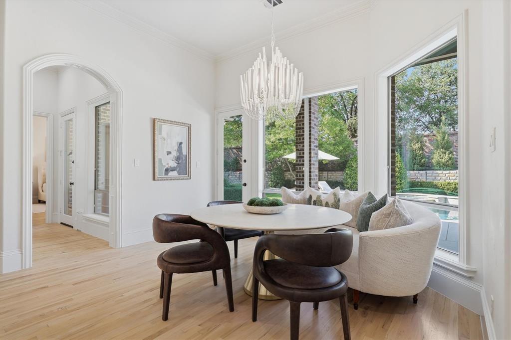 The spacious breakfast area is wrapped in windows overlooking the pool and backyard.