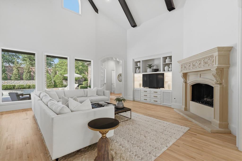 Vaulted and beamed ceilings, refined built-ins and wall of windows define the light-filled family room. Vaulted and beamed ceilings, refined built-ins and wall of windows define the light-filled family room.