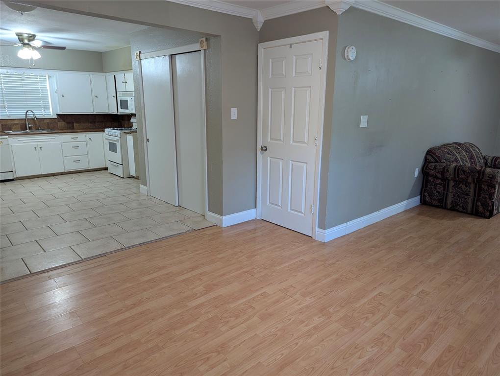 Open transition from the living area into the dining and into the kitchen.