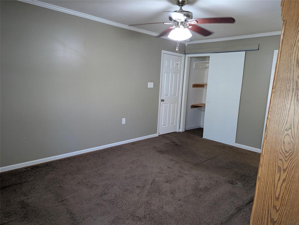 View 2: Another view of the primary suite, highlighting built-in shelving and convenient access to additional storage.