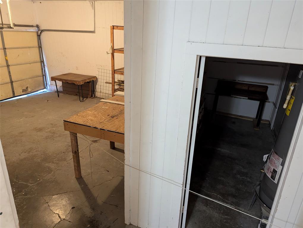 Interior view of the attached 2-car garage featuring a work area, additional storage space, and convenient access to the home.