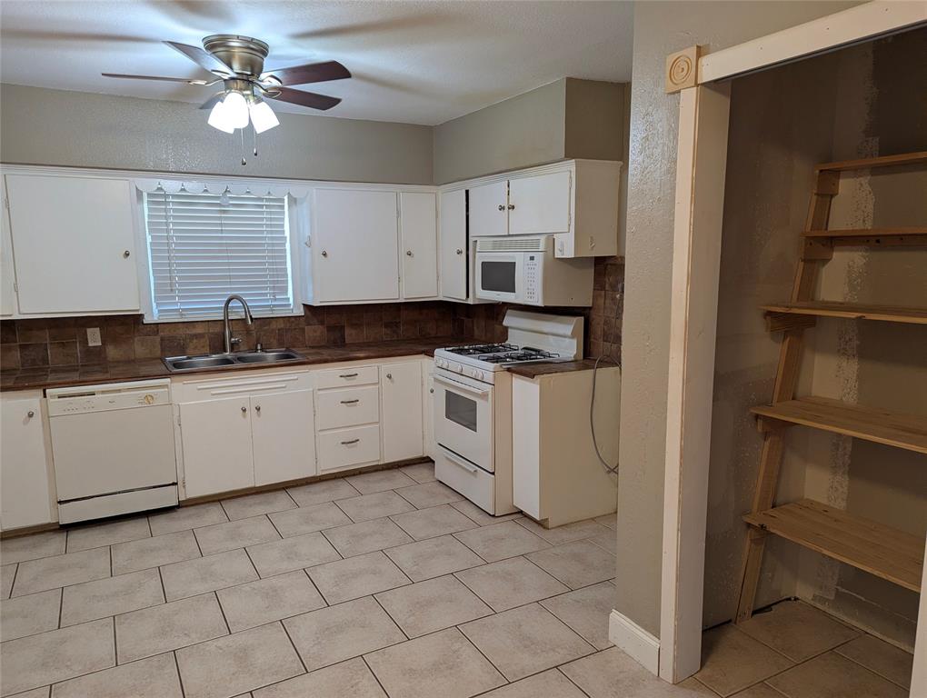 Pantry & Laundry area  currently located in the kitchen.  Potential to relocate laundry to garage or other area of the home.