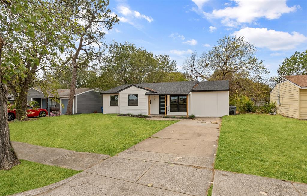 Single-story residence featuring a white exterior, black trim, and a concrete driveway Single-story residence featuring a white exterior, black trim, and a concrete driveway