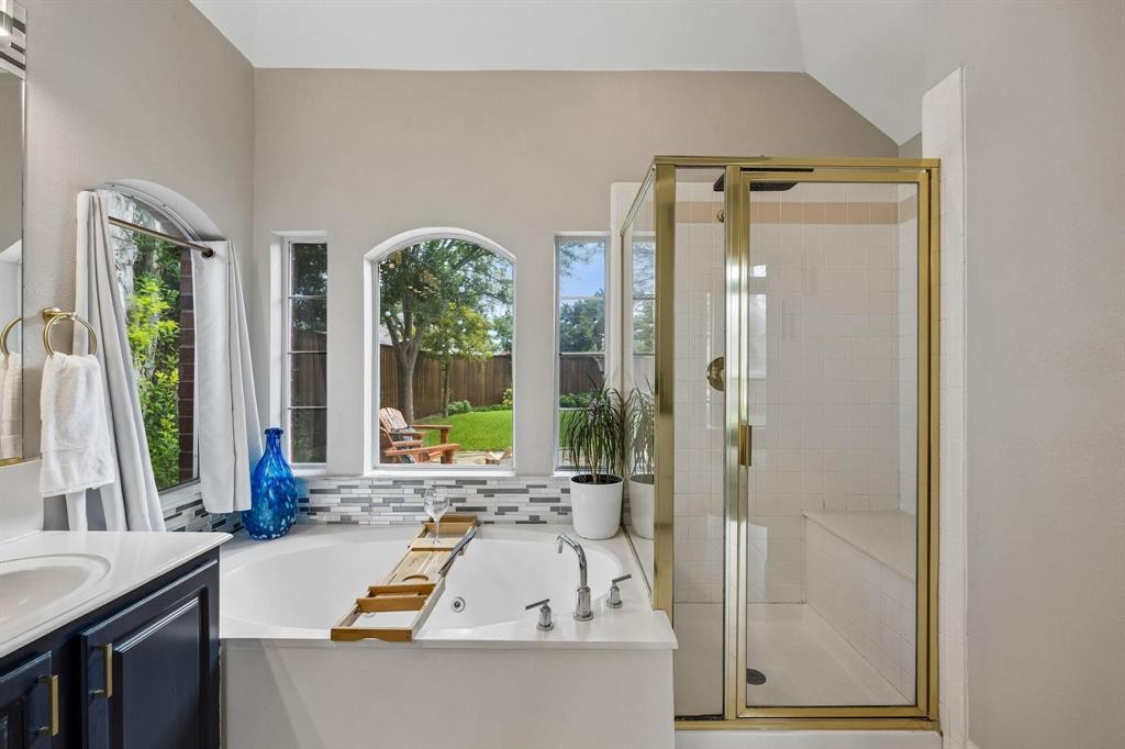 Soaking tub with a mosaic tile surround and multiple arched windows