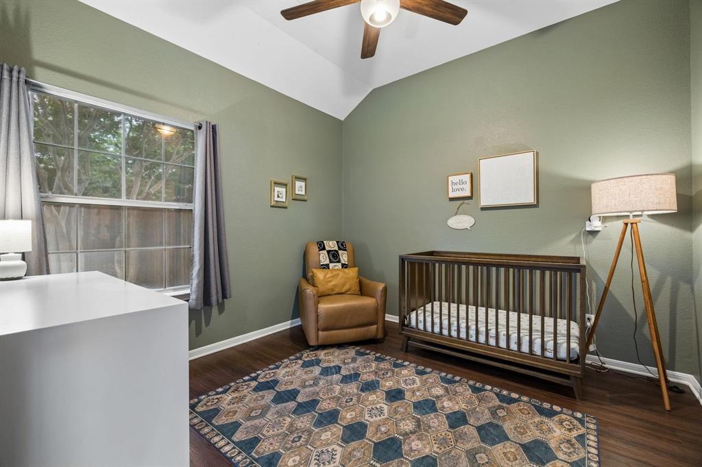 Vaulted ceiling with a ceiling fan, wall-mounted window, dark wood-finish flooring, and light green wall paint